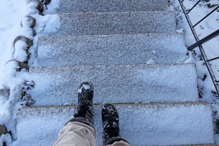 person walking down slippery steps