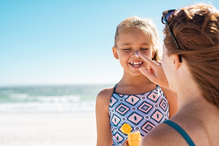 girl having suncream applied