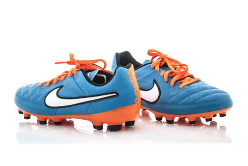 A pair of blue and orange football boots.