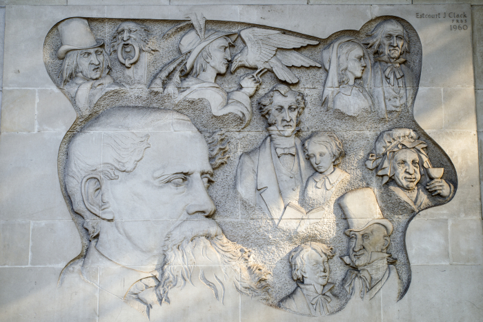 A marble carving of Charles Dickens and some of his characters