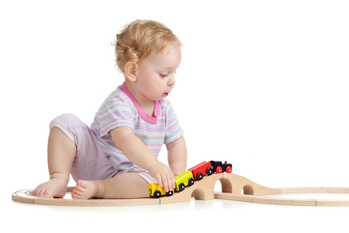 child playing with toy train