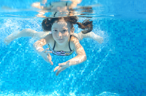 girl swimming under water