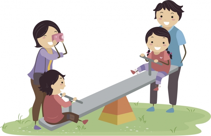 boy and girl on seesaw with parents