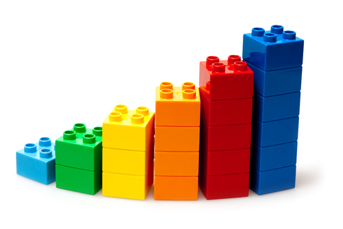 A staircase model made from interlocking plastic blocks in rainbow colours