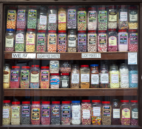 POLPERRO, ENGLAND - AUGUST 26: Jars of sweets displayed in a traditional sweet shop window, August 26, 2013 in Polperro, Cornwall, England. - stock photo