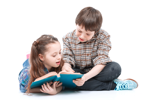 girl and boy looking at a book