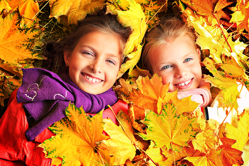 girls in autumn leaves