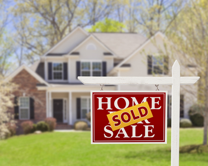 family home with sold sign outside