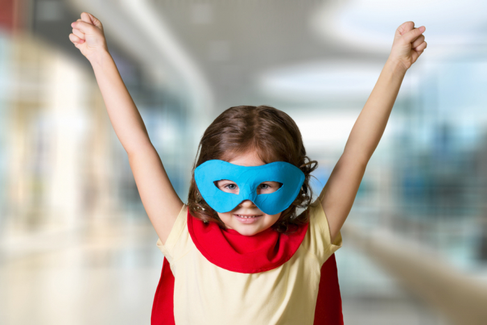 superhero girl in mask and cape