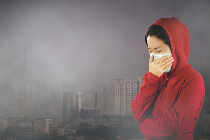 Girl in face mask in smog