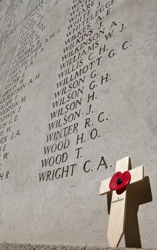 War memorial and cross with a poppy.