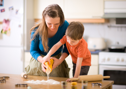 Brother and sister mixing a cake