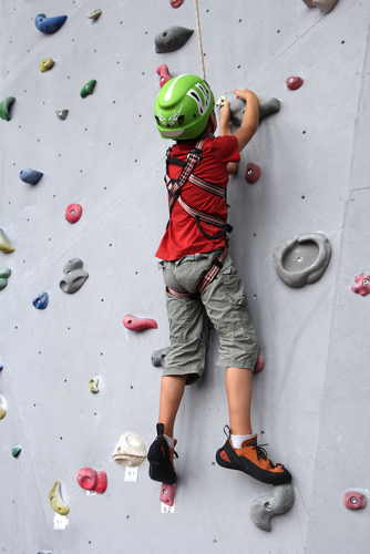 boy rock climbing wall