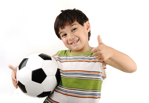 boy with football thumbs up