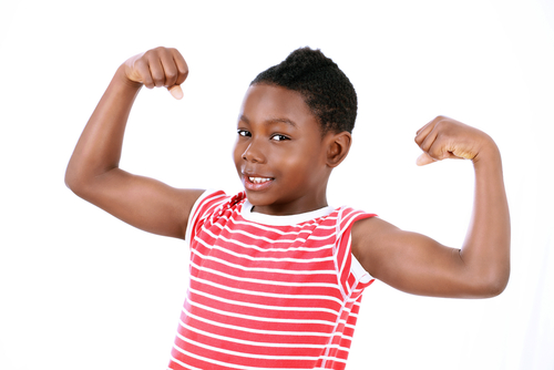 child showing muscles