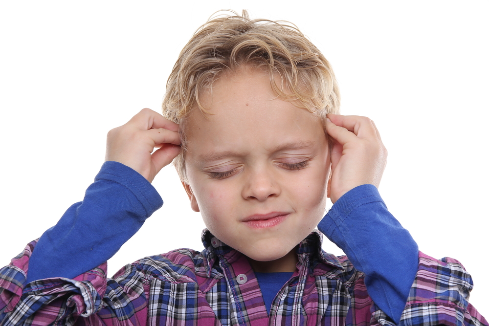 boy holding his head