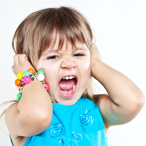 child yelling with hands over ears