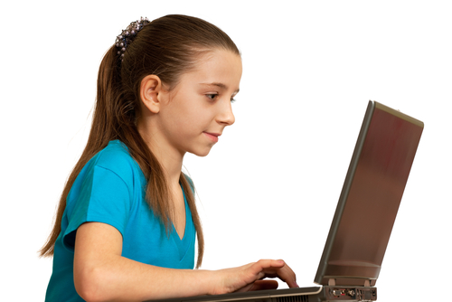 A girl working at a laptop.