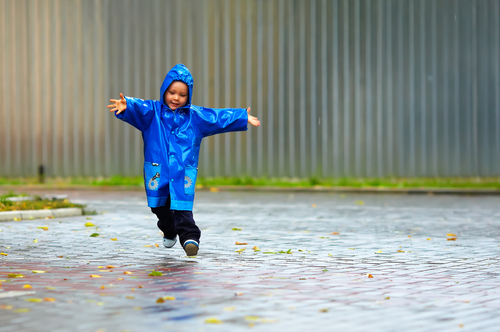 child playing in rain