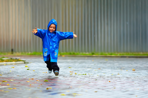 boy playing in the rain