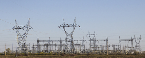 Large high voltage pylons carry the cables from a power station. 