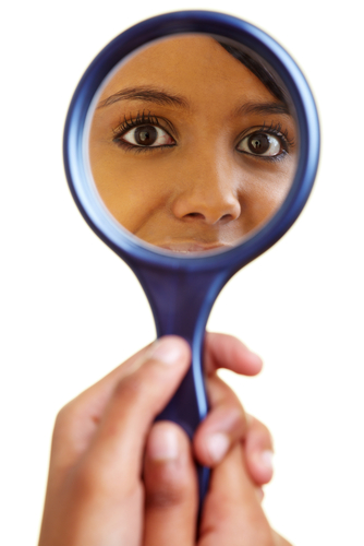 A mirror showing a woman's reflection